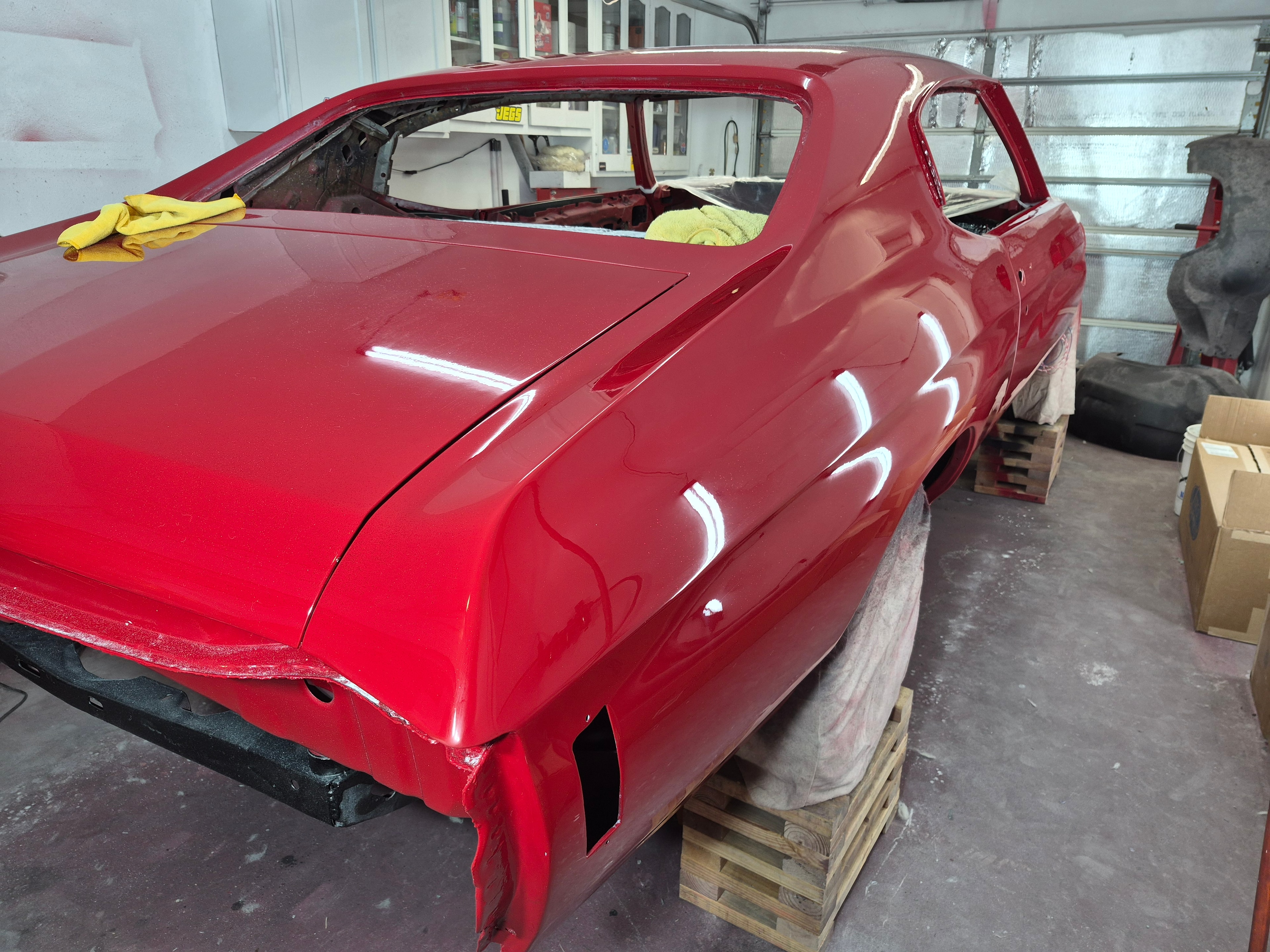 1972 Chevelle Malibu gleaming red side profile being detailed